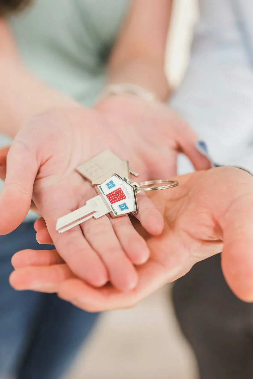 Hands holding a house key